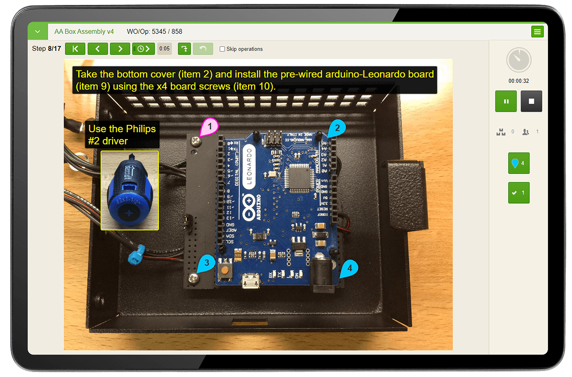 Worker hands holding a tablet with digital work instructions app open.