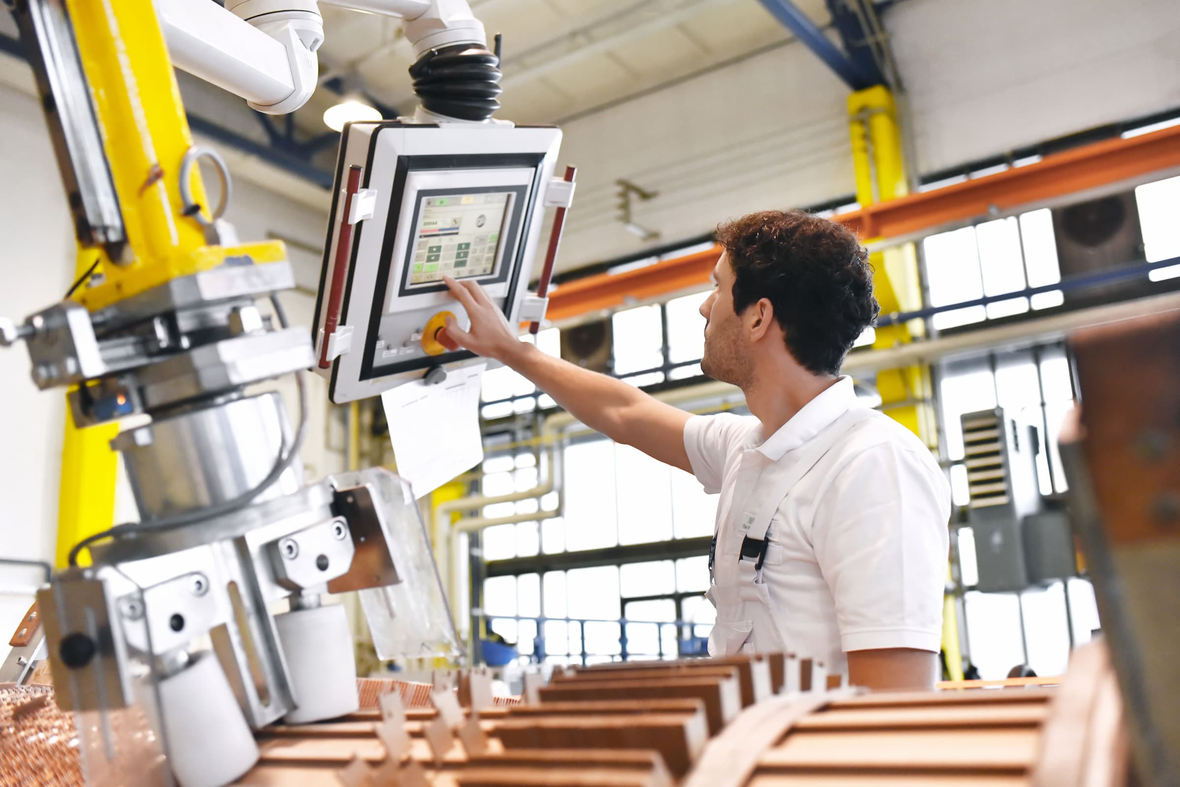 an engineer uses an interactive screen to access digital work instructions for machinery