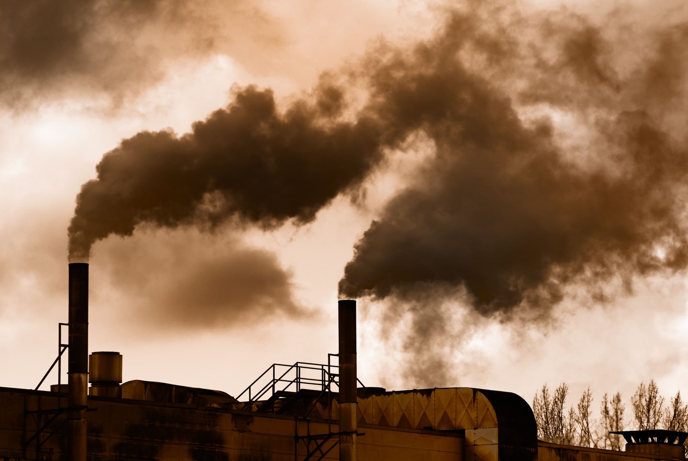 steam blowing out of factory chimneys