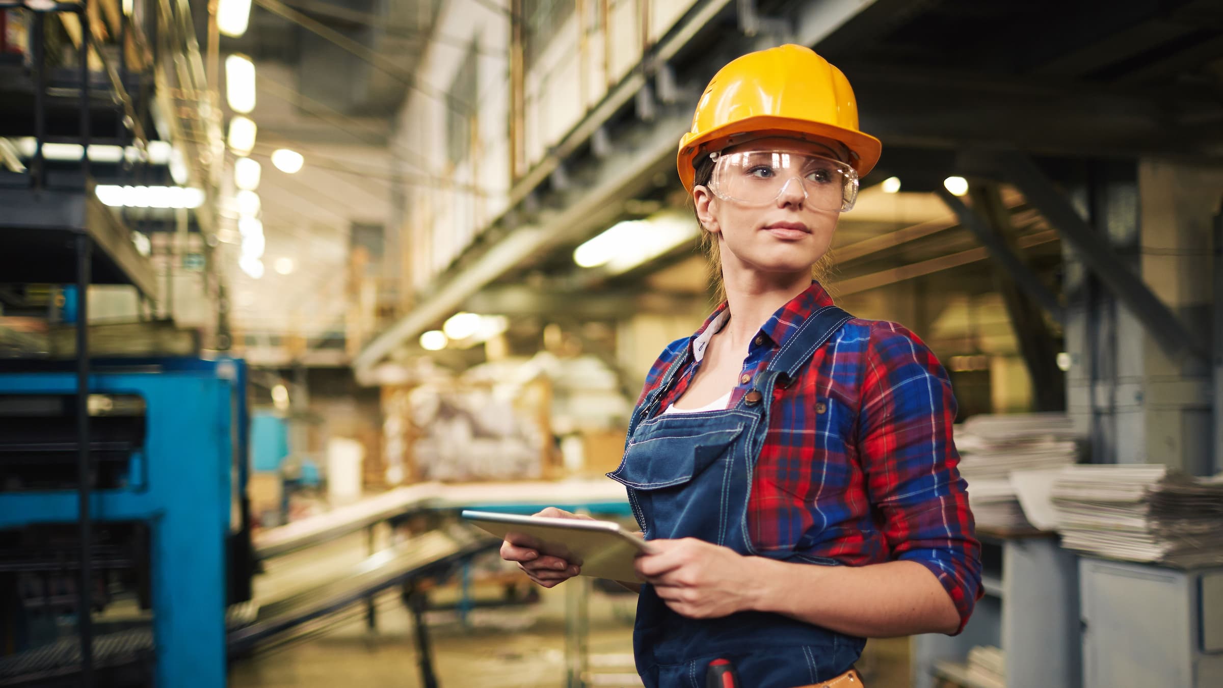 A woman wearing PPE in a factory