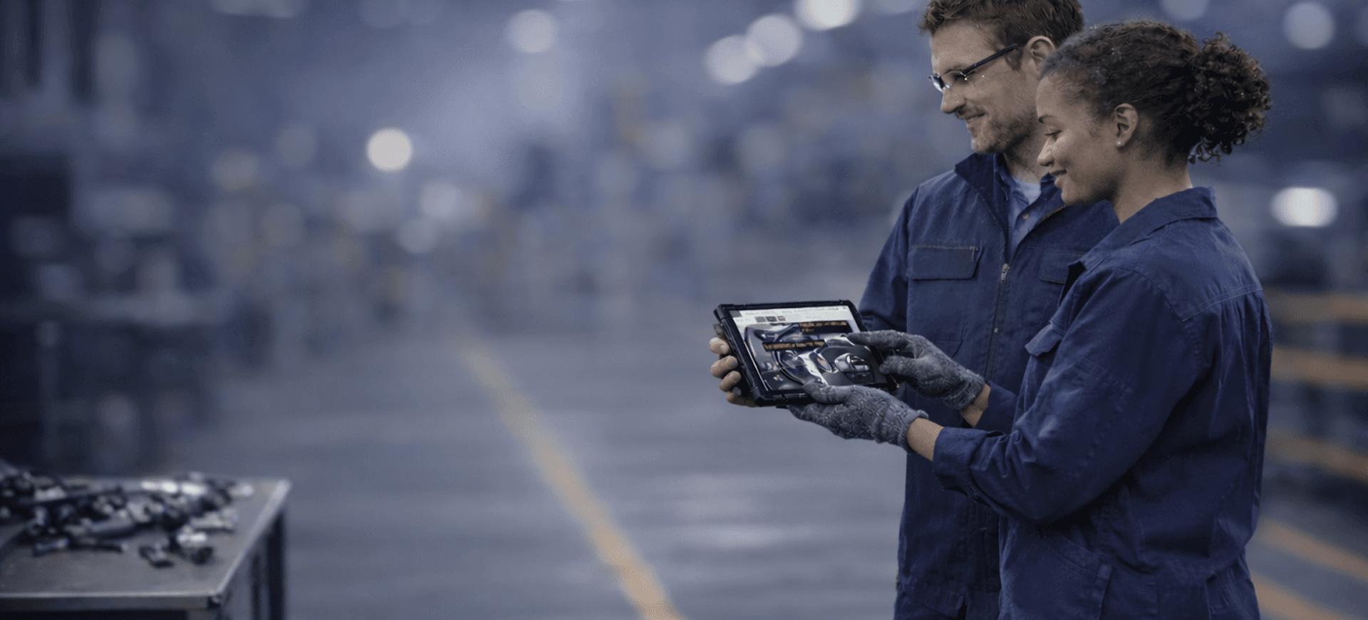 Manufacturing workers looking at a tablet with VKS instructions