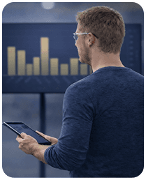 A supervisor looking at VKS KPIs on a large screen while holding a tablet - Thumbnail