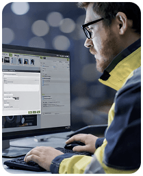 A supervisor looking at VKS KPIs on a large screen while holding a tablet - Thumbnail